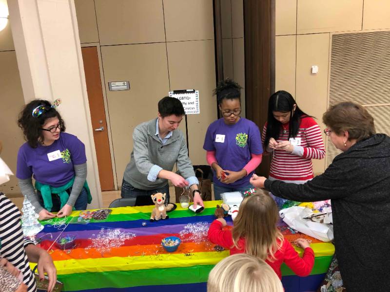 Chris Barrett and student volunteers help children make ornaments