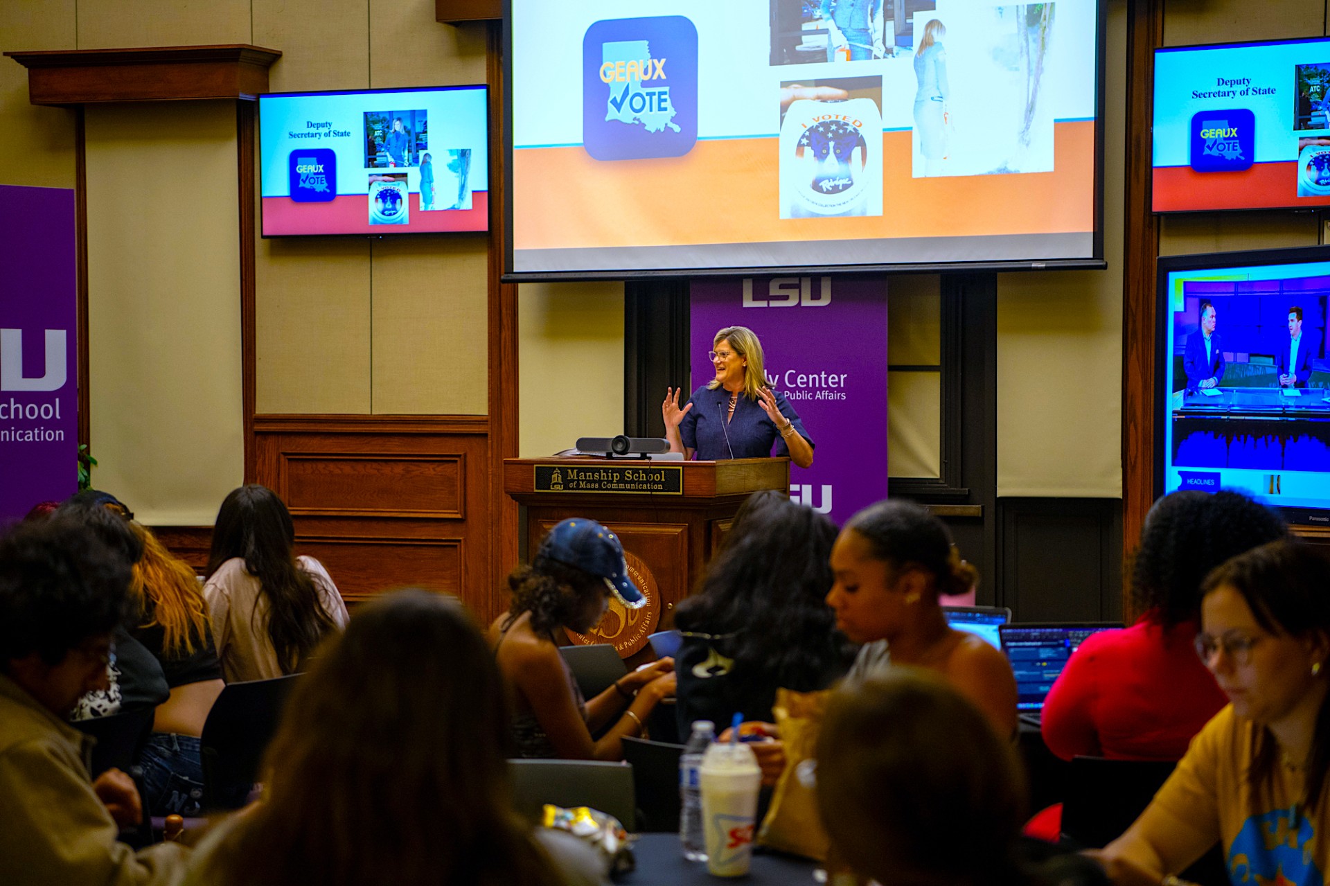 Image of a woman speaking to a crowd at a Reilly Center event.