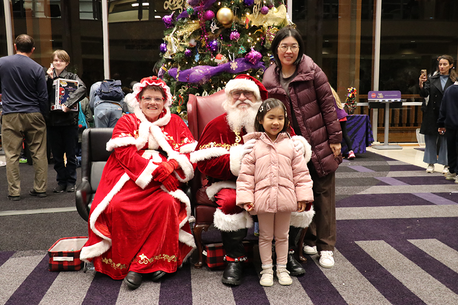 child with Santa and Mrs. Claus